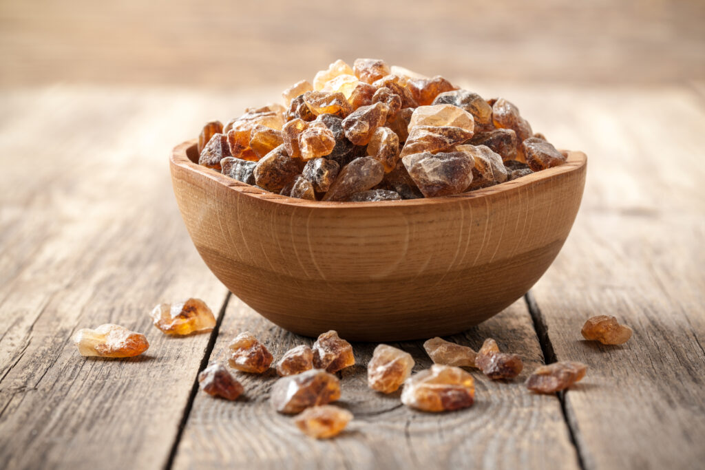 Brown sugar crystals in wooden bowl